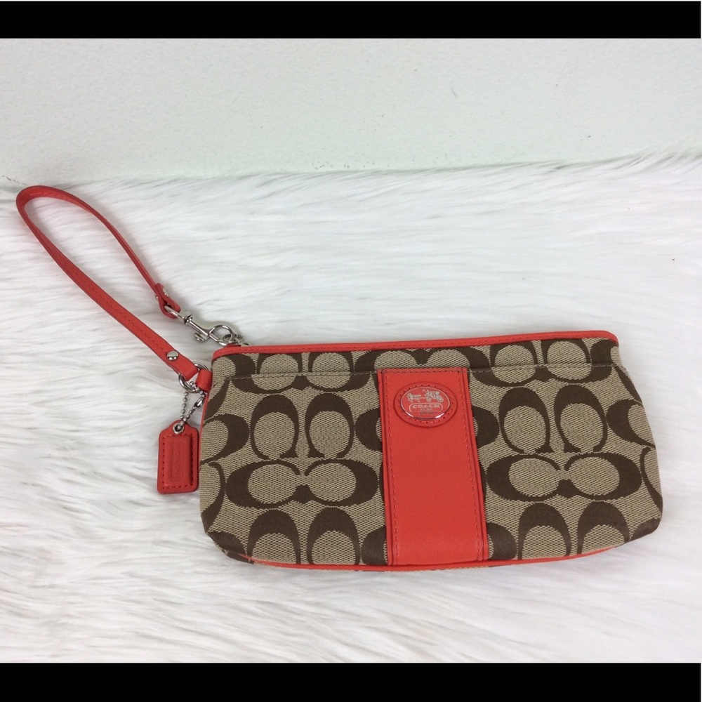 Coach logo wristlet accented with a deep orange.